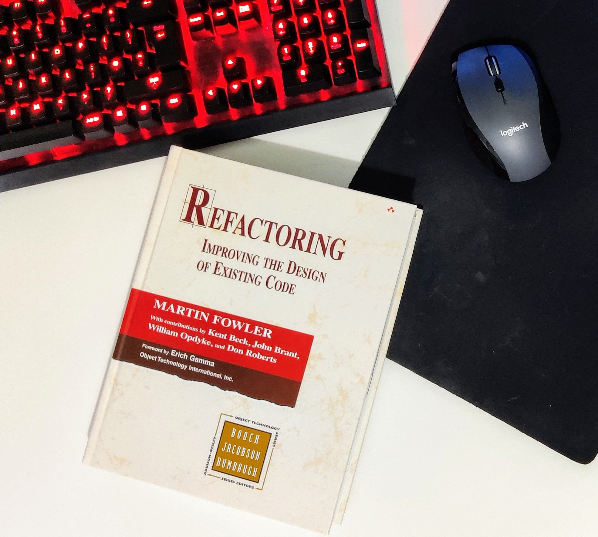 Shows a desk with refactoring book by martin fowler